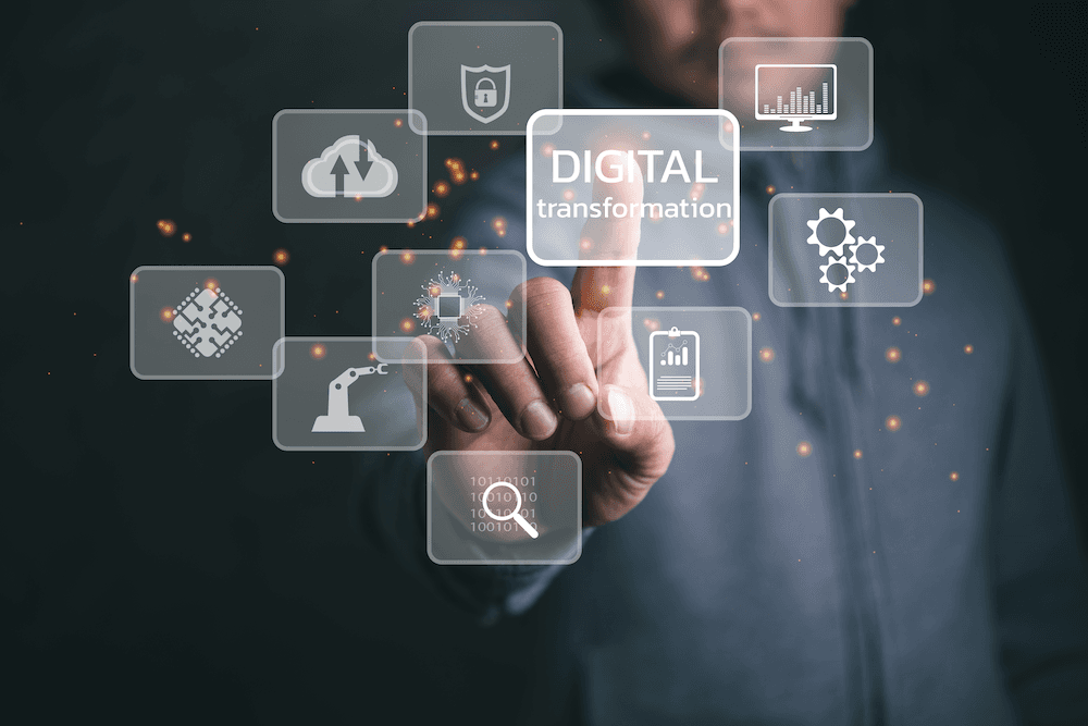 Finger pointing to a digital screen with a graph on it that says "Digital Transformation."