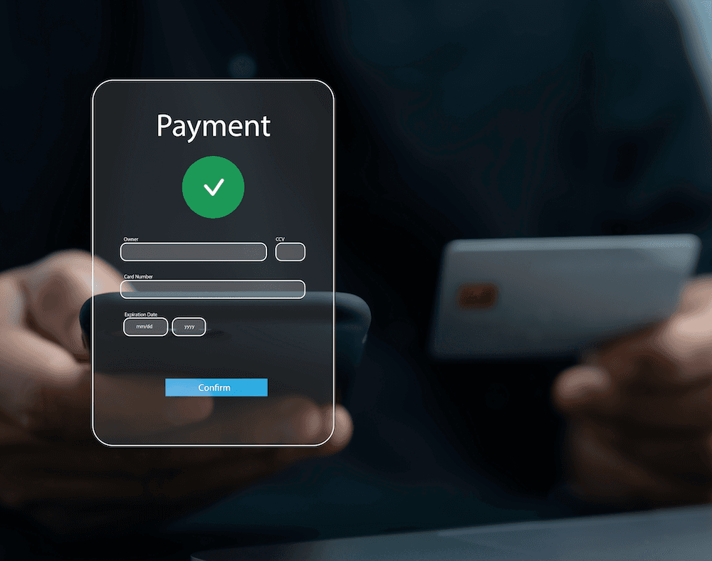 Person processing a payment on a tablet with a credit card and a screen with a successful payment message.